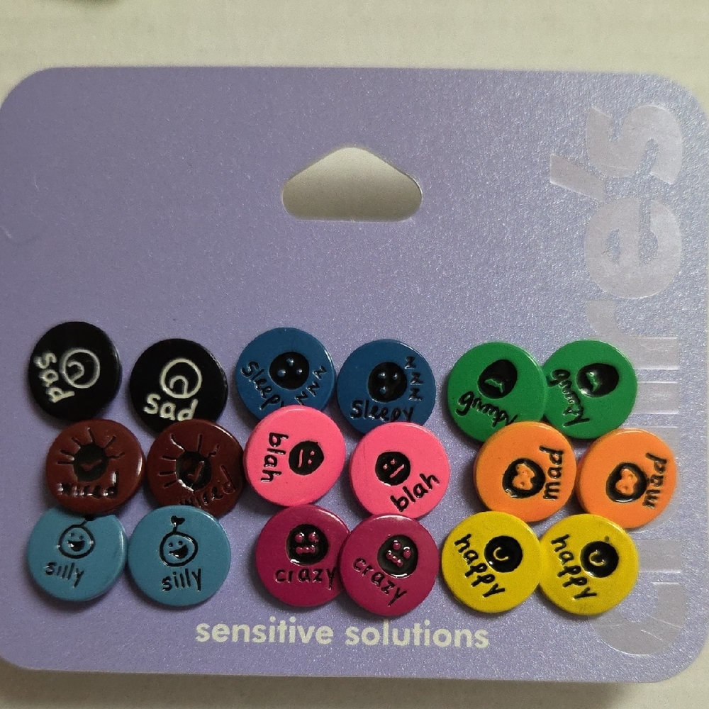 9 Pairs of Circle Earings Each With A Different Emotion From Claire's